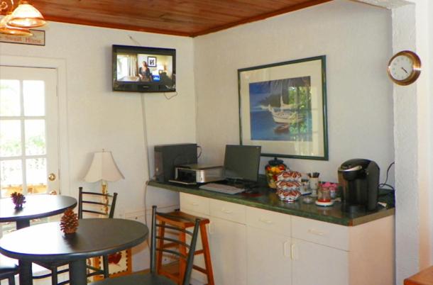 Breakfast room with coffee station, seating, and snacks